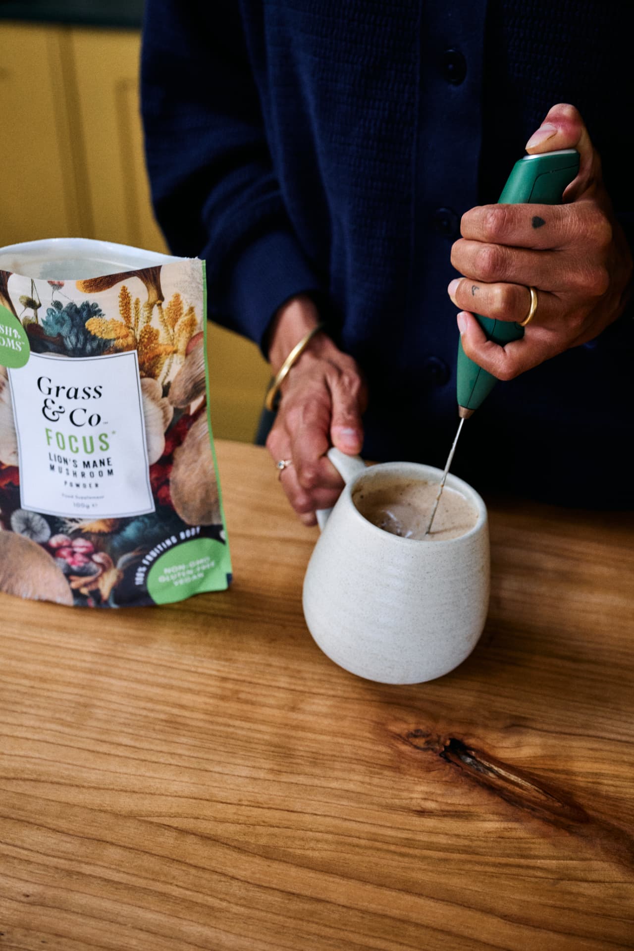 Frothing a FOCUS powder latte beside the pouch