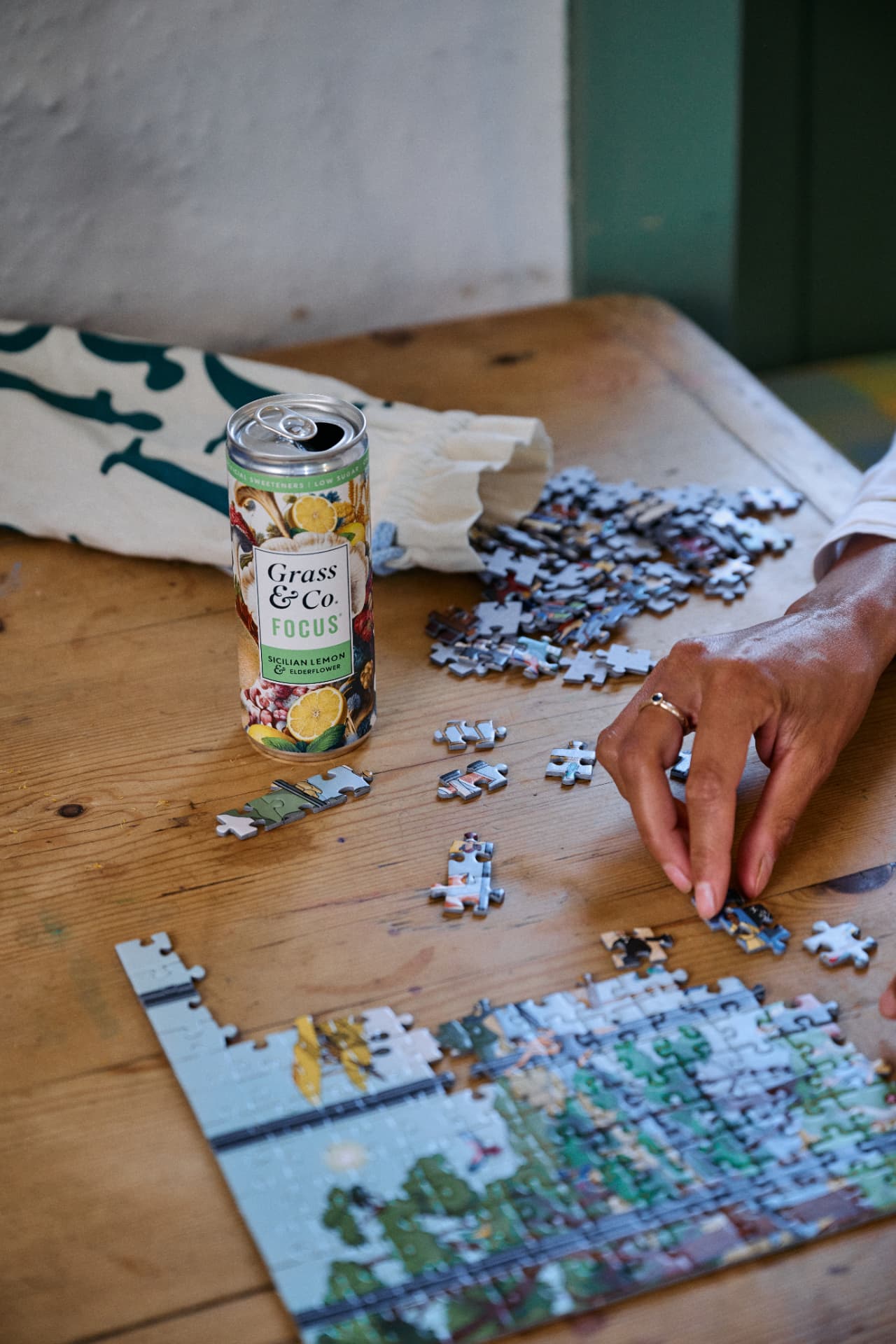 A FOCUS can on the table beside a jigsaw puzzle