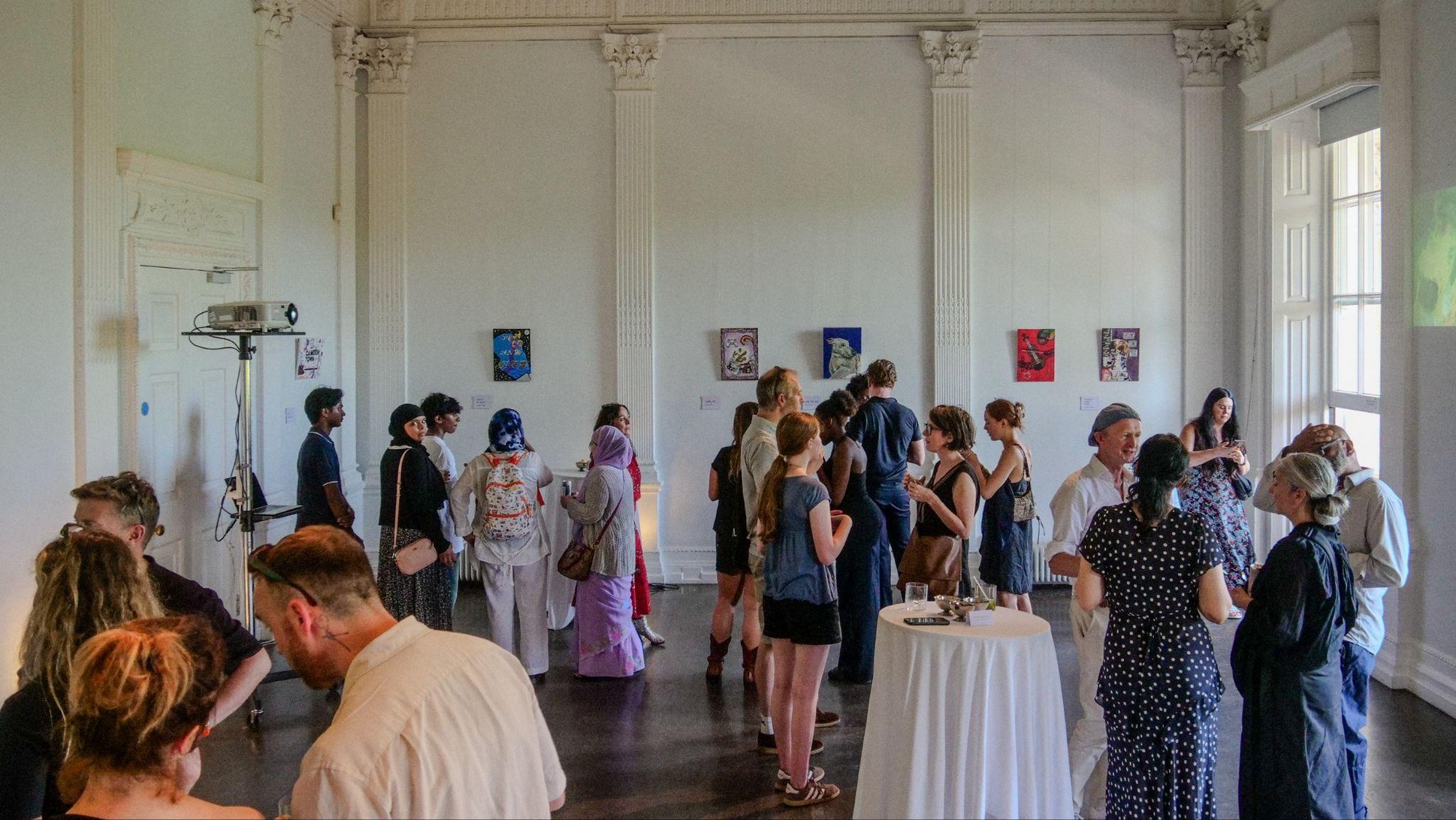 Guests viewing artwork at the HvH Arts workshop exhibition