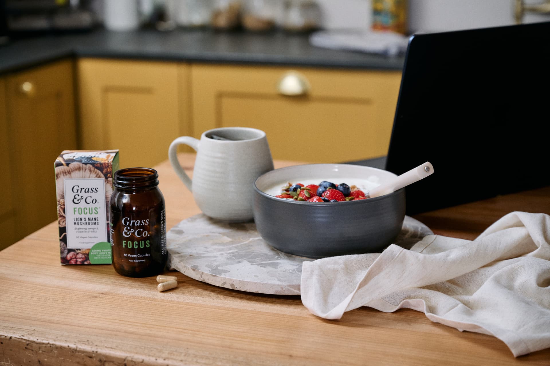 FOCUS capsules beside a breakfast bowl in the kitchen
