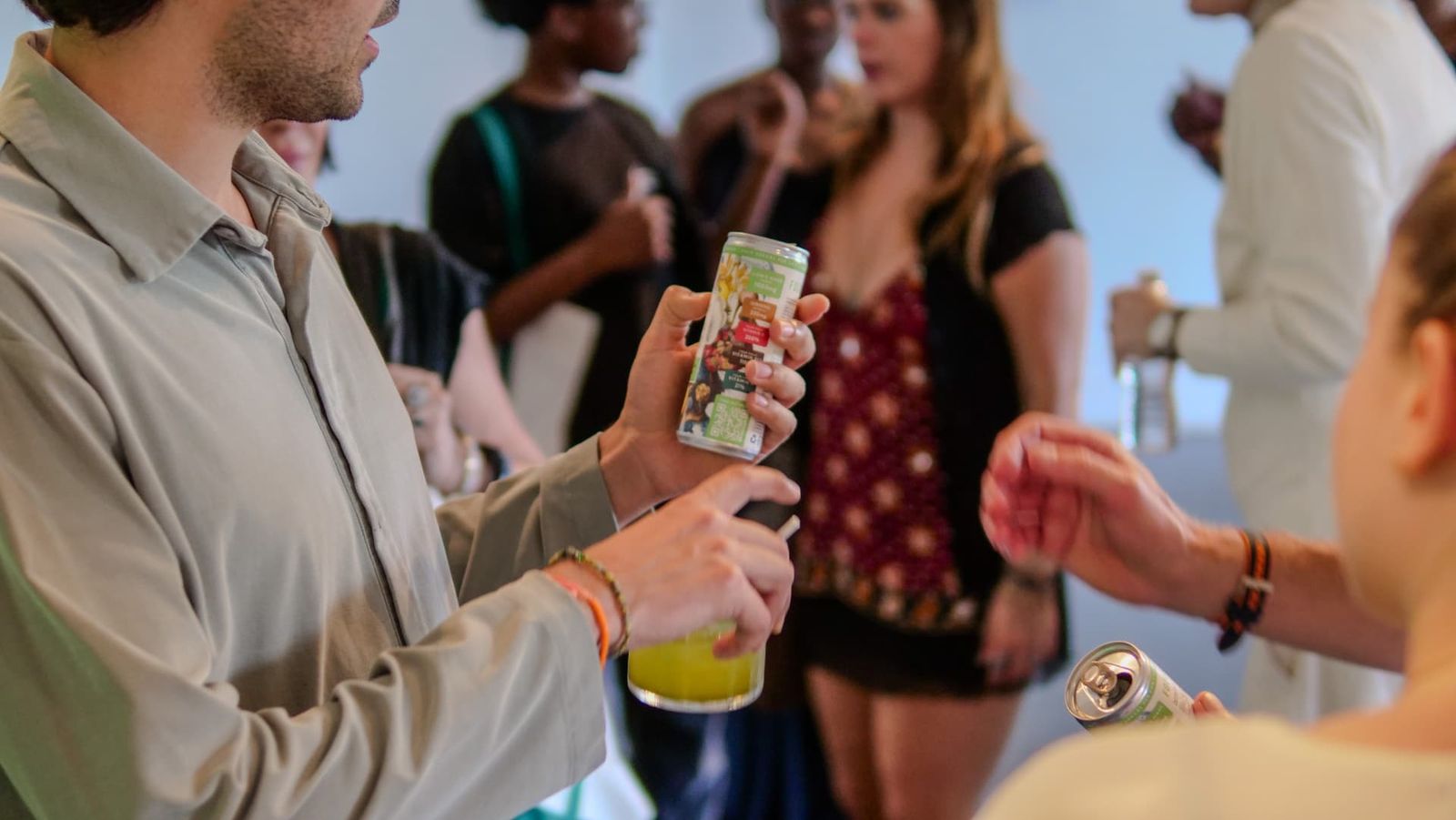 Guests holding Grass & Co. cans at the ICA