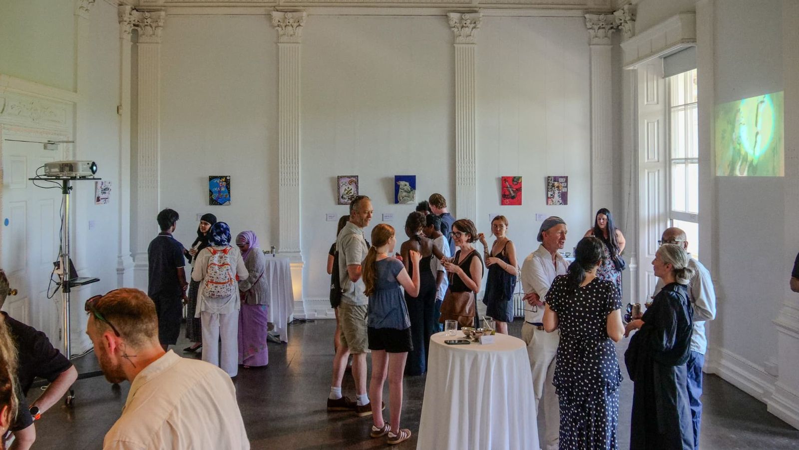 Guests viewing the exhibition in a white pillared room at the ICA