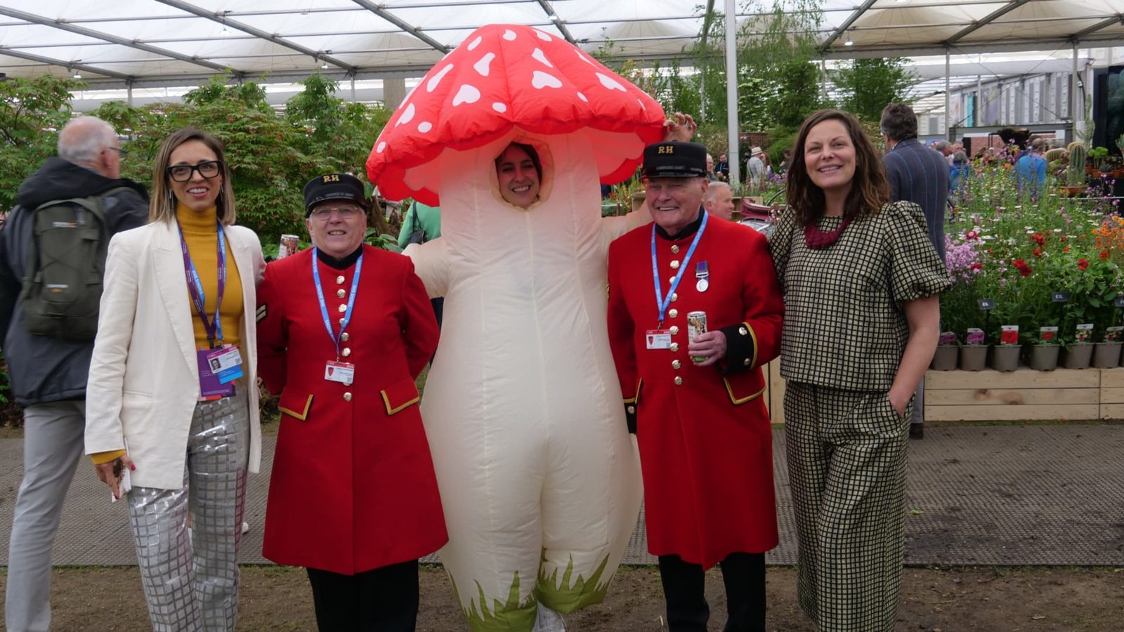 Chelsea Pensioners posing with the Grass and Co. team and a giant mushroom costume