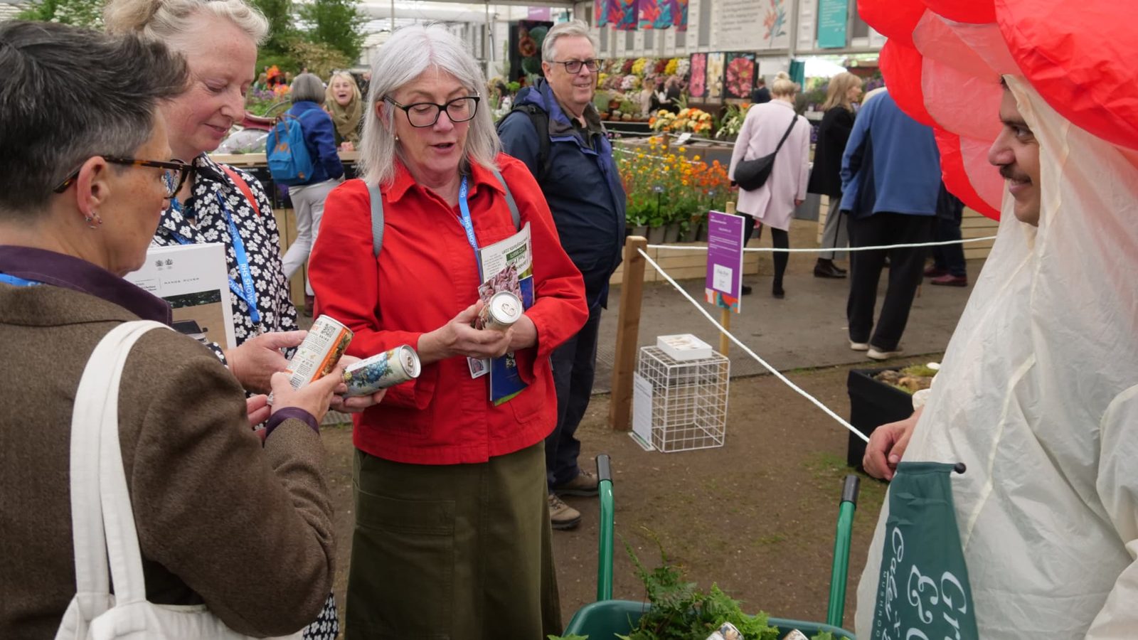 Visitors being handed cans of Grass and Co. drinks to sample at Chelsea