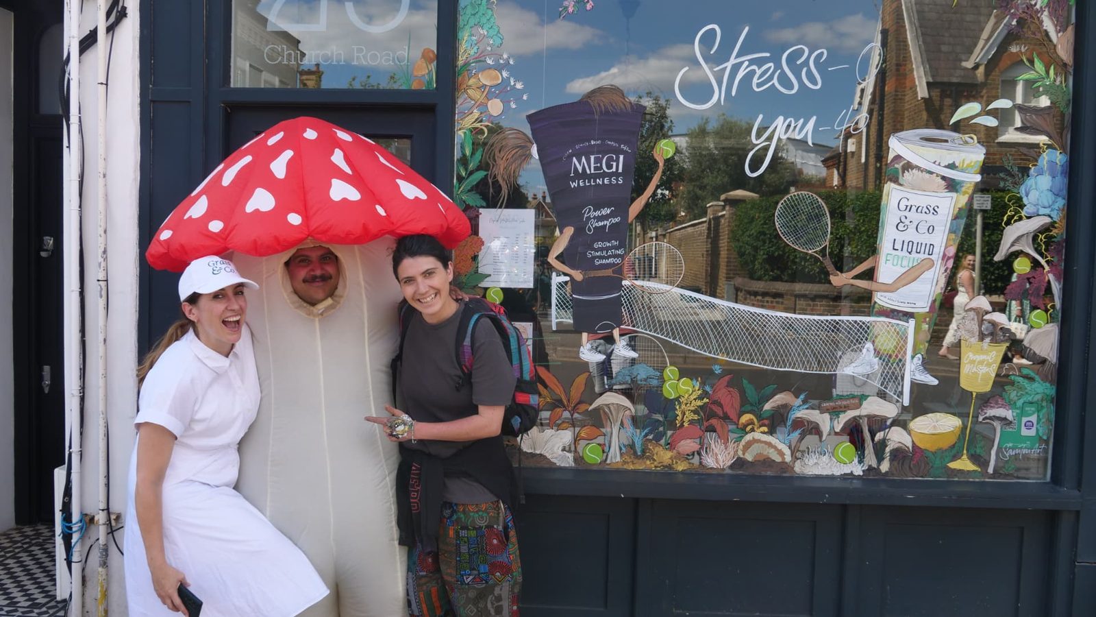 The Grass & Co. team, a giant mushroom costume and artist Sam T Mart outside the painted Wimbledon shopfront