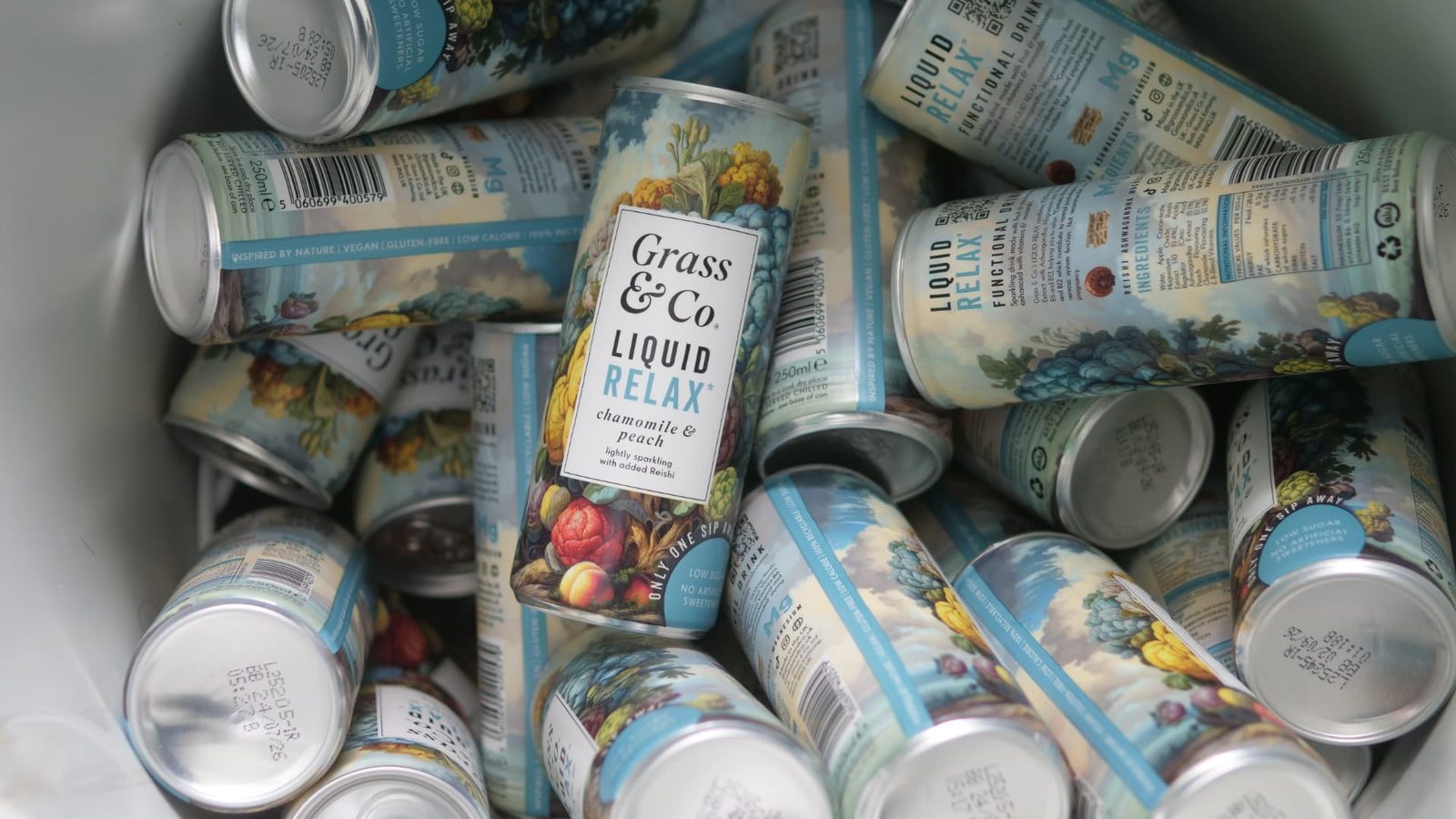 Chilled cans of Grass & Co. Liquid RELAX in an ice bucket