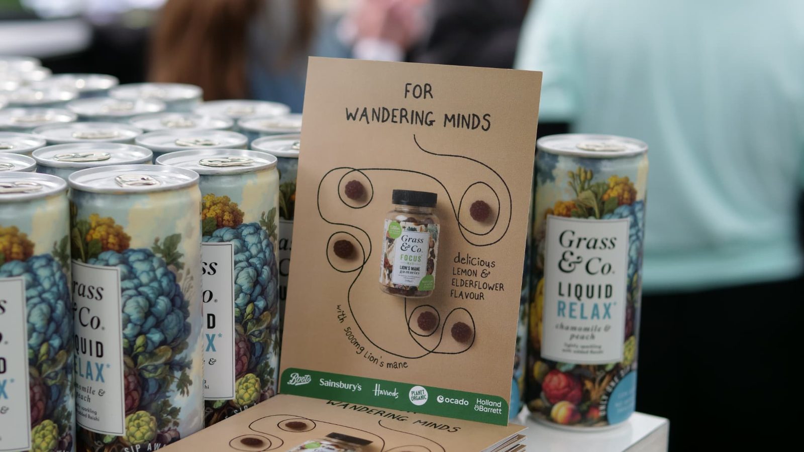 Grass & Co. sampling stand at Women's Prize Live with cans and a For Wandering Minds card